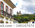 Houses and churches nestled among the hills 140147474