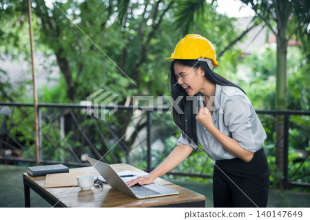 Asian female architects clenched her fist and shouted YEAH!! Glad to know that the client likes her work and agrees to sign a contract. Successful project. Asian female architects clenched her fist and shouted YEAH!! Glad to know that the client likes her work and agrees to sign a contract. Successful project. 140147649