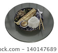 Isolated on a white background, this Japanese set meal is presented on a round tabletop. A deep-blue patterned plate holds a grilled, golden-brown fish fillet, a rounded mound of white rice, and a 140147689