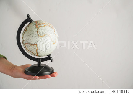 Hand holding globe, global travel international business geography and world connection concept Hand holding globe, global travel international business geography and world connection concept 140148312