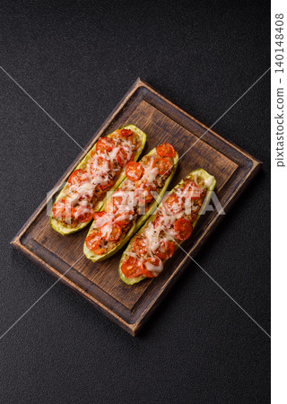 Baked zucchini half with minced meat, tomatoes, cheese, salt, and spices. Zucchini with minced meat Baked zucchini half with minced meat, tomatoes, cheese, salt, and spices. Zucchini with minced meat 140148408