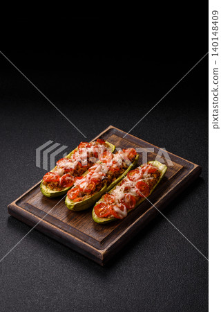 Baked zucchini half with minced meat, tomatoes, cheese, salt, and spices. Zucchini with minced meat Baked zucchini half with minced meat, tomatoes, cheese, salt, and spices. Zucchini with minced meat 140148409