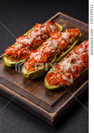 Baked zucchini half with minced meat, tomatoes, cheese, salt, and spices. Zucchini with minced meat Baked zucchini half with minced meat, tomatoes, cheese, salt, and spices. Zucchini with minced meat 140148411