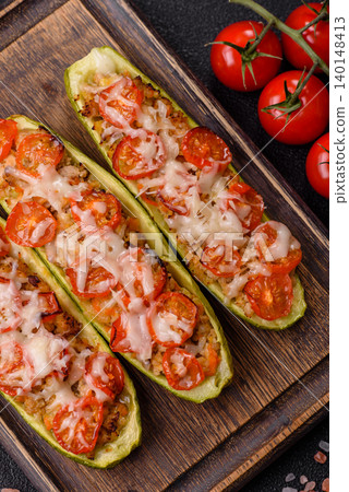Baked zucchini half with minced meat, tomatoes, cheese, salt, and spices. Zucchini with minced meat Baked zucchini half with minced meat, tomatoes, cheese, salt, and spices. Zucchini with minced meat 140148413