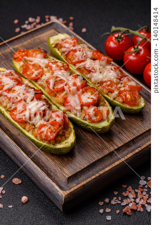 Baked zucchini half with minced meat, tomatoes, cheese, salt, and spices. Zucchini with minced meat Baked zucchini half with minced meat, tomatoes, cheese, salt, and spices. Zucchini with minced meat 140148414