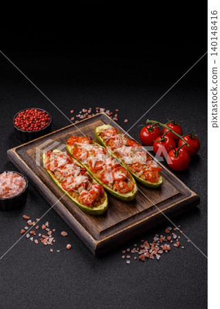 Baked zucchini half with minced meat, tomatoes, cheese, salt, and spices. Zucchini with minced meat Baked zucchini half with minced meat, tomatoes, cheese, salt, and spices. Zucchini with minced meat 140148416