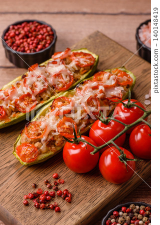 Baked zucchini half with minced meat, tomatoes, cheese, salt, and spices. Zucchini with minced meat Baked zucchini half with minced meat, tomatoes, cheese, salt, and spices. Zucchini with minced meat 140148419