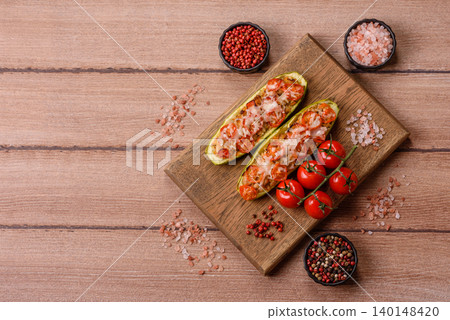 Baked zucchini half with minced meat, tomatoes, cheese, salt, and spices. Zucchini with minced meat Baked zucchini half with minced meat, tomatoes, cheese, salt, and spices. Zucchini with minced meat 140148420