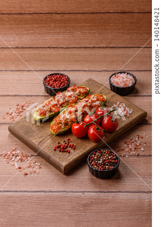 Baked zucchini half with minced meat, tomatoes, cheese, salt, and spices. Zucchini with minced meat Baked zucchini half with minced meat, tomatoes, cheese, salt, and spices. Zucchini with minced meat 140148421