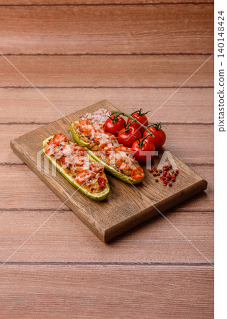 Baked zucchini half with minced meat, tomatoes, cheese, salt, and spices. Zucchini with minced meat Baked zucchini half with minced meat, tomatoes, cheese, salt, and spices. Zucchini with minced meat 140148424