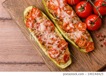 Baked zucchini half with minced meat, tomatoes, cheese, salt, and spices. Zucchini with minced meat Baked zucchini half with minced meat, tomatoes, cheese, salt, and spices. Zucchini with minced meat 140148425