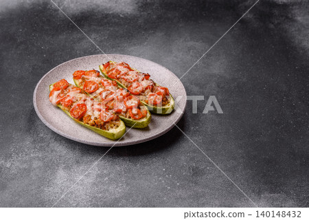 Baked zucchini half with minced meat, tomatoes, cheese, salt, and spices. Zucchini with minced meat Baked zucchini half with minced meat, tomatoes, cheese, salt, and spices. Zucchini with minced meat 140148432
