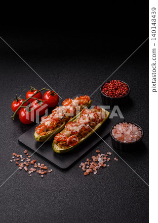 Baked zucchini half with minced meat, tomatoes, cheese, salt, and spices. Zucchini with minced meat Baked zucchini half with minced meat, tomatoes, cheese, salt, and spices. Zucchini with minced meat 140148439