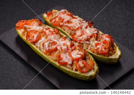 Baked zucchini half with minced meat, tomatoes, cheese, salt, and spices. Zucchini with minced meat Baked zucchini half with minced meat, tomatoes, cheese, salt, and spices. Zucchini with minced meat 140148442