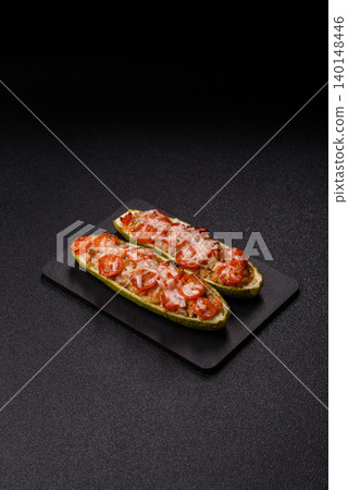 Baked zucchini half with minced meat, tomatoes, cheese, salt, and spices. Zucchini with minced meat Baked zucchini half with minced meat, tomatoes, cheese, salt, and spices. Zucchini with minced meat 140148446