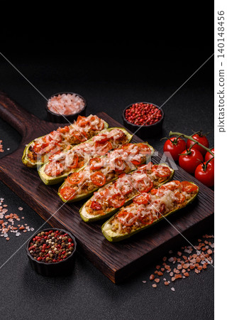 Baked zucchini half with minced meat, tomatoes, cheese, salt, and spices. Zucchini with minced meat Baked zucchini half with minced meat, tomatoes, cheese, salt, and spices. Zucchini with minced meat 140148456