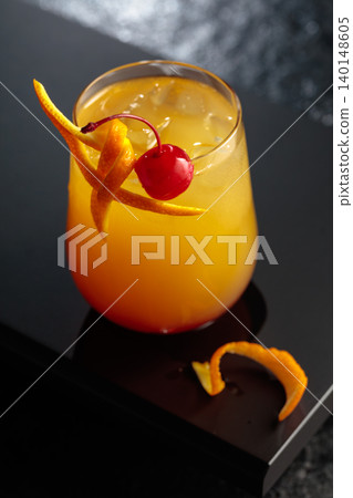 Cocktail Tequila sunrise with orange juice, silver tequila, grenadine, and ice. Cocktail Tequila sunrise with orange juice, silver tequila, grenadine, and ice. 140148605