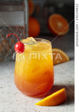 Cocktail Tequila sunrise with ice, orange juice, grenadine, and silver tequila. Cocktail Tequila sunrise with ice, orange juice, grenadine, and silver tequila. 140148612