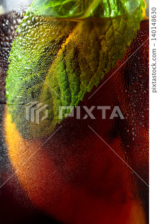 Cocktail with lemon, ice and mint in misted glass. Cocktail with lemon, ice and mint in misted glass. 140148630