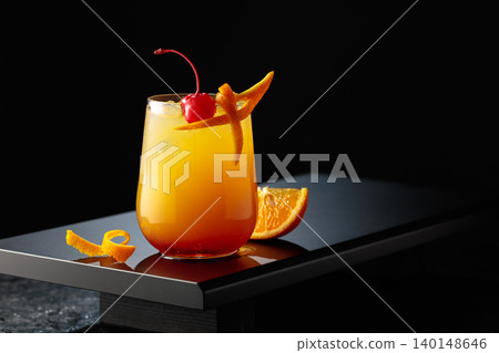 Cocktail Tequila sunrise with orange juice, silver tequila, grenadine, and ice. Cocktail Tequila sunrise with orange juice, silver tequila, grenadine, and ice. 140148646