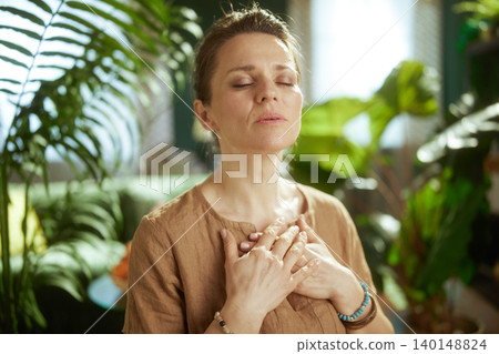 Middle-Aged Woman Practicing Calm Breathing and Meditation Middle-Aged Woman Practicing Calm Breathing and Meditation 140148824