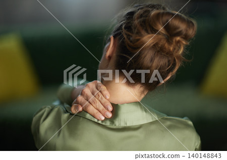 Over the Shoulder View of Woman with Neck Discomfort Over the Shoulder View of Woman with Neck Discomfort 140148843