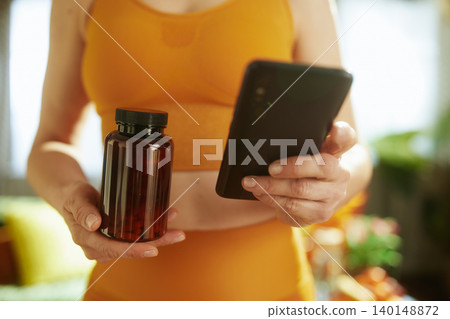 Healthy Woman Using App to Track Supplements 140148872