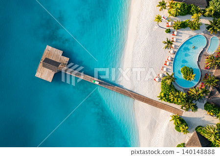 Stunning aerial Maldives wooden pier infinity pool white sand turquoise lagoon breathtaking luxury resort top view tropical paradise serene idyllic coastal escape drone dreamy vibrant exotic scenic Stunning aerial Maldives wooden pier infinity pool white sand turquoise lagoon breathtaking luxury resort top view tropical paradise serene idyllic coastal escape drone dreamy vibrant exotic scenic 140148888