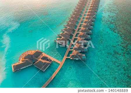 Gorgeous aerial Maldives overwater villas turquoise reef lagoon breathtaking luxury resort top view tropical paradise serene idyllic coastal escape drone dreamy vibrant exotic getaway scenic Gorgeous aerial Maldives overwater villas turquoise reef lagoon breathtaking luxury resort top view tropical paradise serene idyllic coastal escape drone dreamy vibrant exotic getaway scenic 140148889