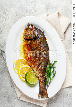 baked dorado fish, in the oven, fried dorado, with spices and herbs, on a white plate, top view, homemade, no people, baked dorado fish, in the oven, fried dorado, with spices and herbs, on a white plate, top view, homemade, no people, 140148941