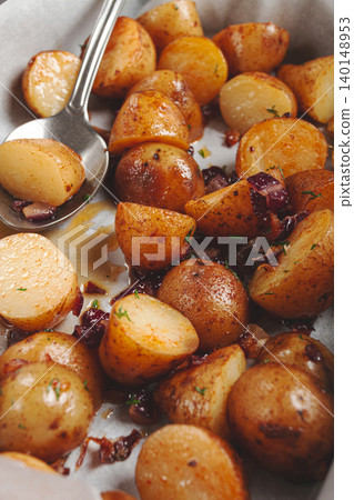 Crispy roasted potatoes with herbs and spices baked to perfection in a home kitchen setting 140148953