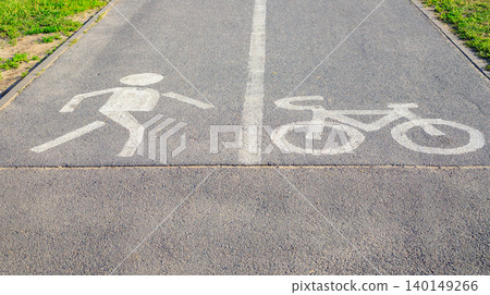 Shared asphalt path for pedestrians and cyclists, road infrastructure and traffic safety markings for walking and bicycle Shared asphalt path for pedestrians and cyclists, road infrastructure and traffic safety markings for walking and bicycle 140149266