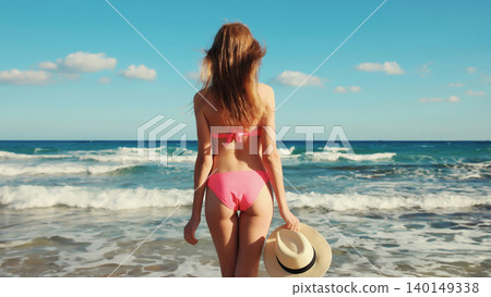 Summer vacation, relaxed beautiful young woman in swimsuit, tourist hat on the beach on sea coast 140149338