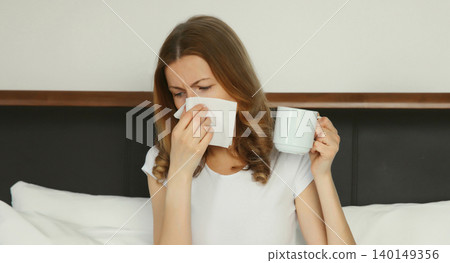 Sick exhausted young woman sneezing blow nose using tissue, unhealthy suffering girl feels unwell Sick exhausted young woman sneezing blow nose using tissue, unhealthy suffering girl feels unwell 140149356