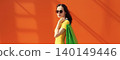 Portrait of stylish beautiful young woman posing with shopping bags 140149446