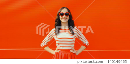 Beautiful happy smiling young brunette woman posing in red heart shaped sunglasses, skirt in city Beautiful happy smiling young brunette woman posing in red heart shaped sunglasses, skirt in city 140149465
