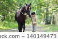 Teenager boy kid with horse walking in summer forest, horseback riding 140149473