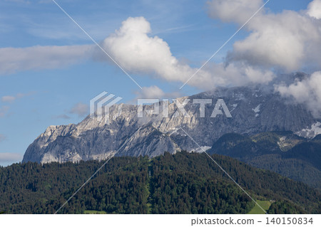 Rugged Alpine Mountain Ridge With Blue Sky and Soft Clouds Rugged Alpine Mountain Ridge With Blue Sky and Soft Clouds 140150834