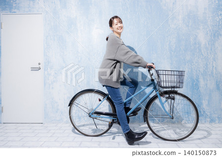 Woman riding a bicycle Woman riding a bicycle 140150873