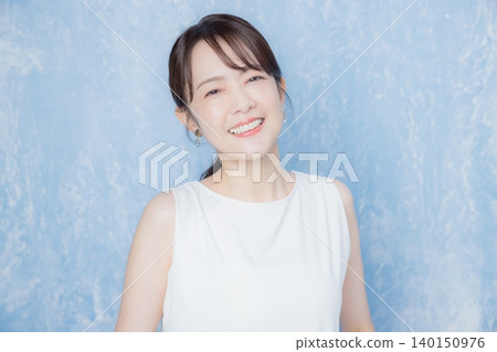 Woman smiling with hands on face Woman smiling with hands on face 140150976