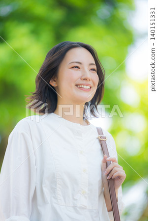 A woman walking in the fresh green A woman walking in the fresh green 140151331