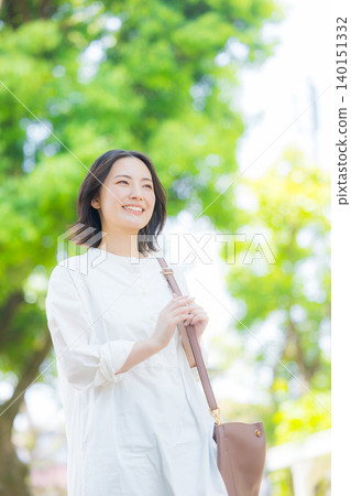 A woman walking in the fresh green 140151332