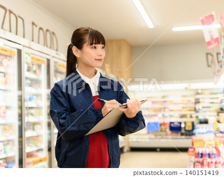 woman working in a supermarket woman working in a supermarket 140151419