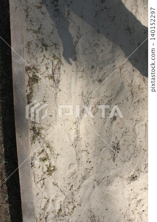 light white sand with shadows on a sunny day. Textured background 140152297
