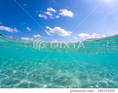 A half-submerged photograph of the beautiful white sand beach on the uninhabited island of Agena-shikishima. Agena-shikishima, Okinawa Prefecture, Shimajiri District, Kerama Islands, Zamami Island - 2025 A half-submerged photograph of the beautiful white sand beach on the uninhabited island of Agena-shikishima. Agena-shikishima, Okinawa Prefecture, Shimajiri District, Kerama Islands, Zamami Island - 2025 140153095