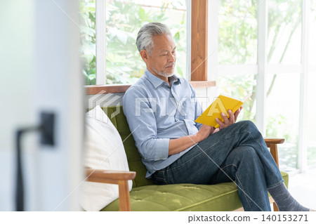 Senior male reading Senior male reading 140153271