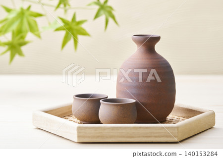 A sake set featuring a sake cup and carafe, representing the image of Japanese sake. A sake set featuring a sake cup and carafe, representing the image of Japanese sake. 140153284