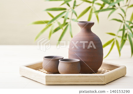 A sake set featuring a sake cup and carafe, representing the image of Japanese sake. A sake set featuring a sake cup and carafe, representing the image of Japanese sake. 140153290