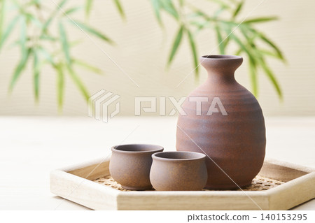 A sake set featuring a sake cup and carafe, representing the image of Japanese sake. A sake set featuring a sake cup and carafe, representing the image of Japanese sake. 140153295