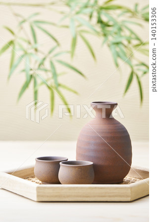 A sake set featuring a sake cup and carafe, representing the image of Japanese sake. A sake set featuring a sake cup and carafe, representing the image of Japanese sake. 140153306